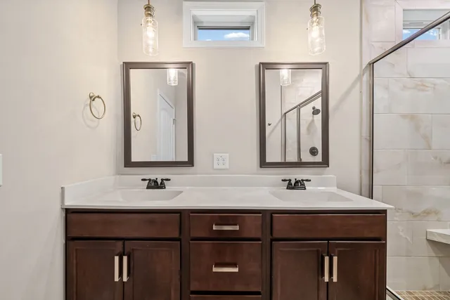 a bathroom with a double vanity sink and a mirror
