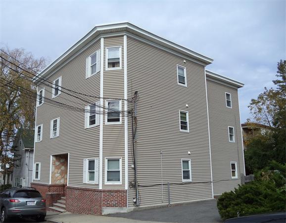 13-15 Amity Street Lynn, MA 01902 - Photo 14 of 15 a front view of a house with a yard