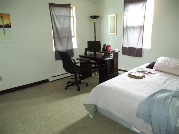 13-15 Amity Street Lynn, MA 01902 - Photo 6 of 15 a bedroom with a bed and a window