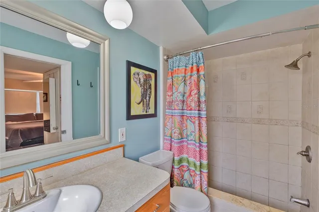 a bathroom with a sink mirror vanity and toilet