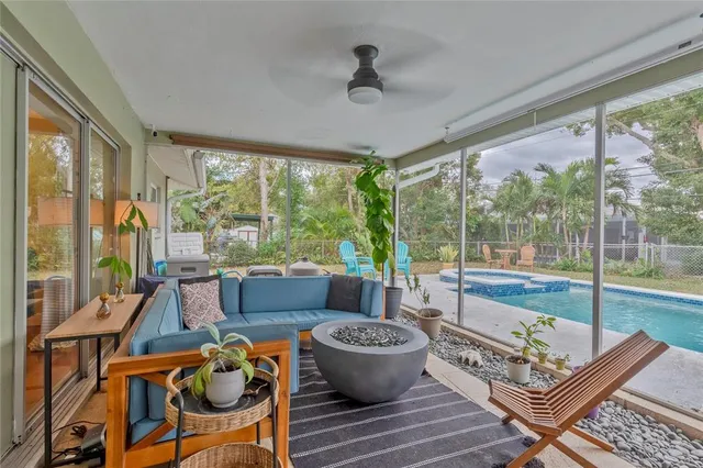 a living room with furniture and a floor to ceiling window