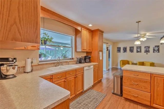 a kitchen with stainless steel appliances kitchen island granite countertop a sink and cabinets