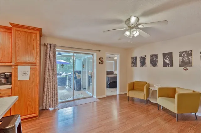 a view of an livingroom with furniture wooden floor and window