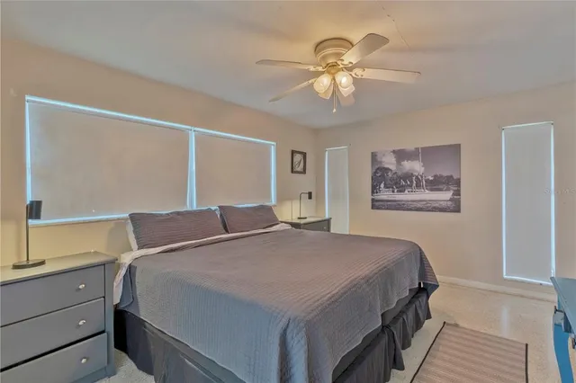 a bedroom with a large bed and a chandelier