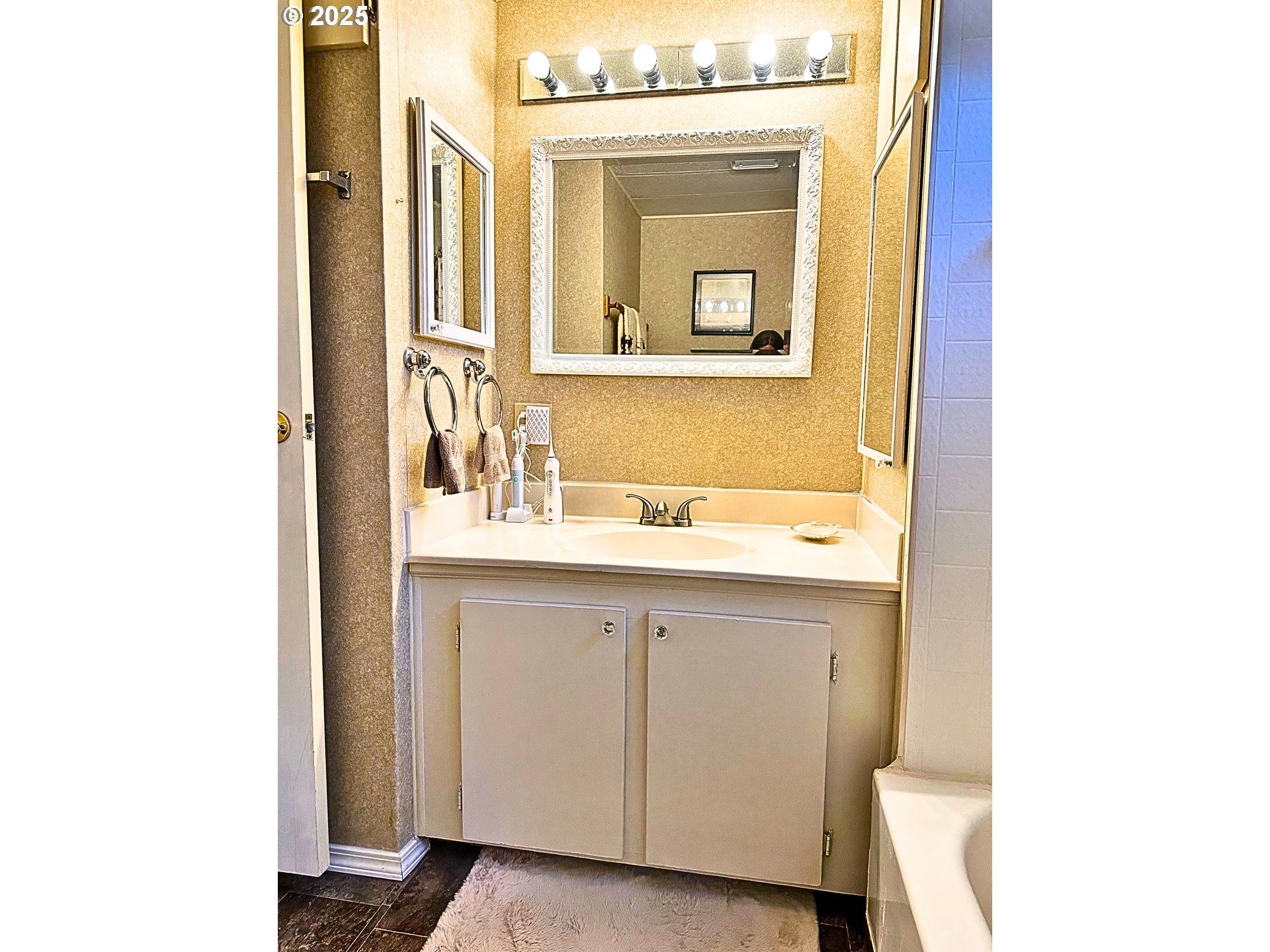1600 Rhododendron Drive, Unit 218 Florence, OR 97439 - Photo 11 of 40 a bathroom with a sink a mirror and a vanity