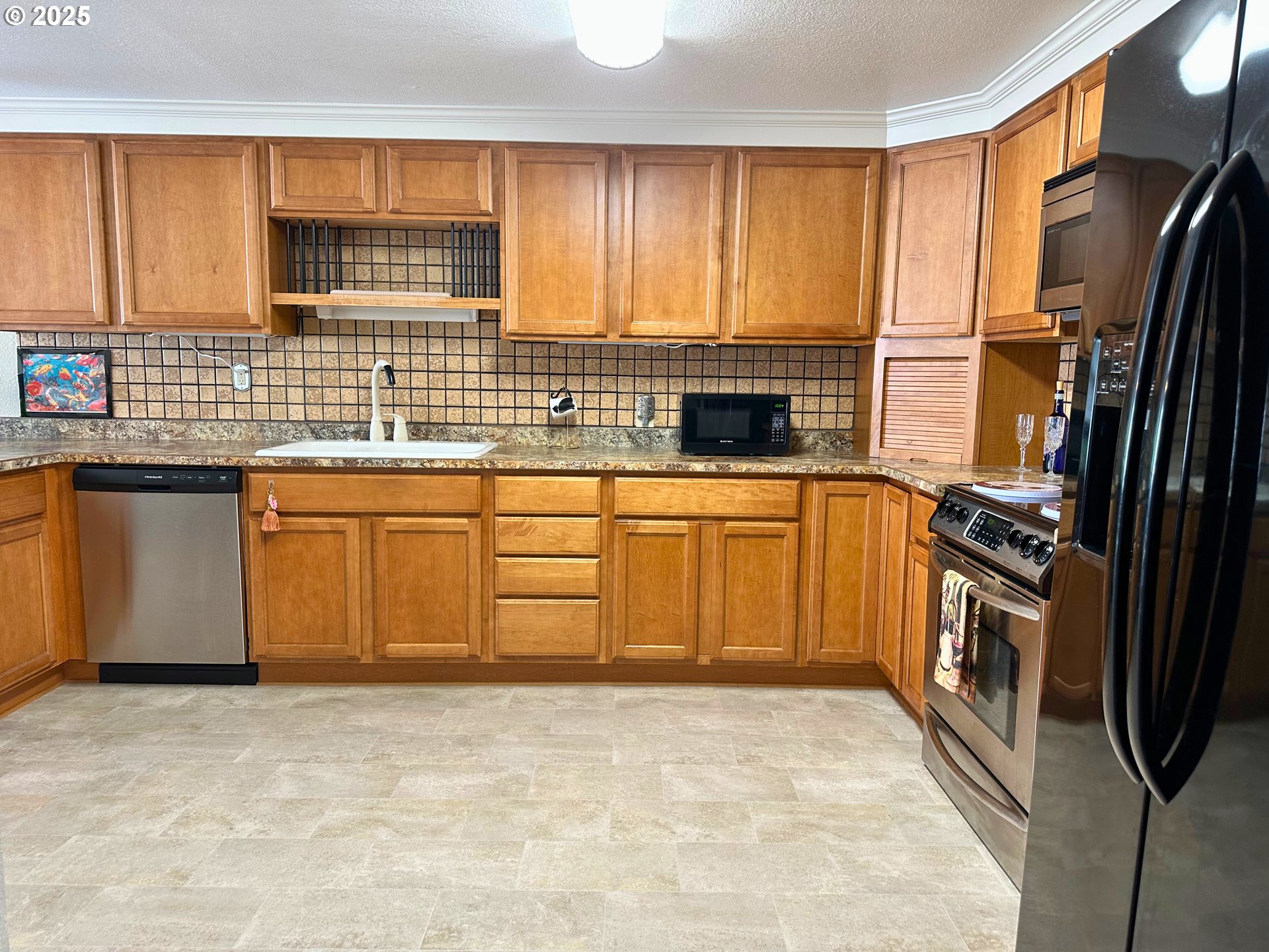 1600 Rhododendron Drive, Unit 218 Florence, OR 97439 - Photo 6 of 40 a kitchen with stainless steel appliances granite countertop a stove sink and cabinets