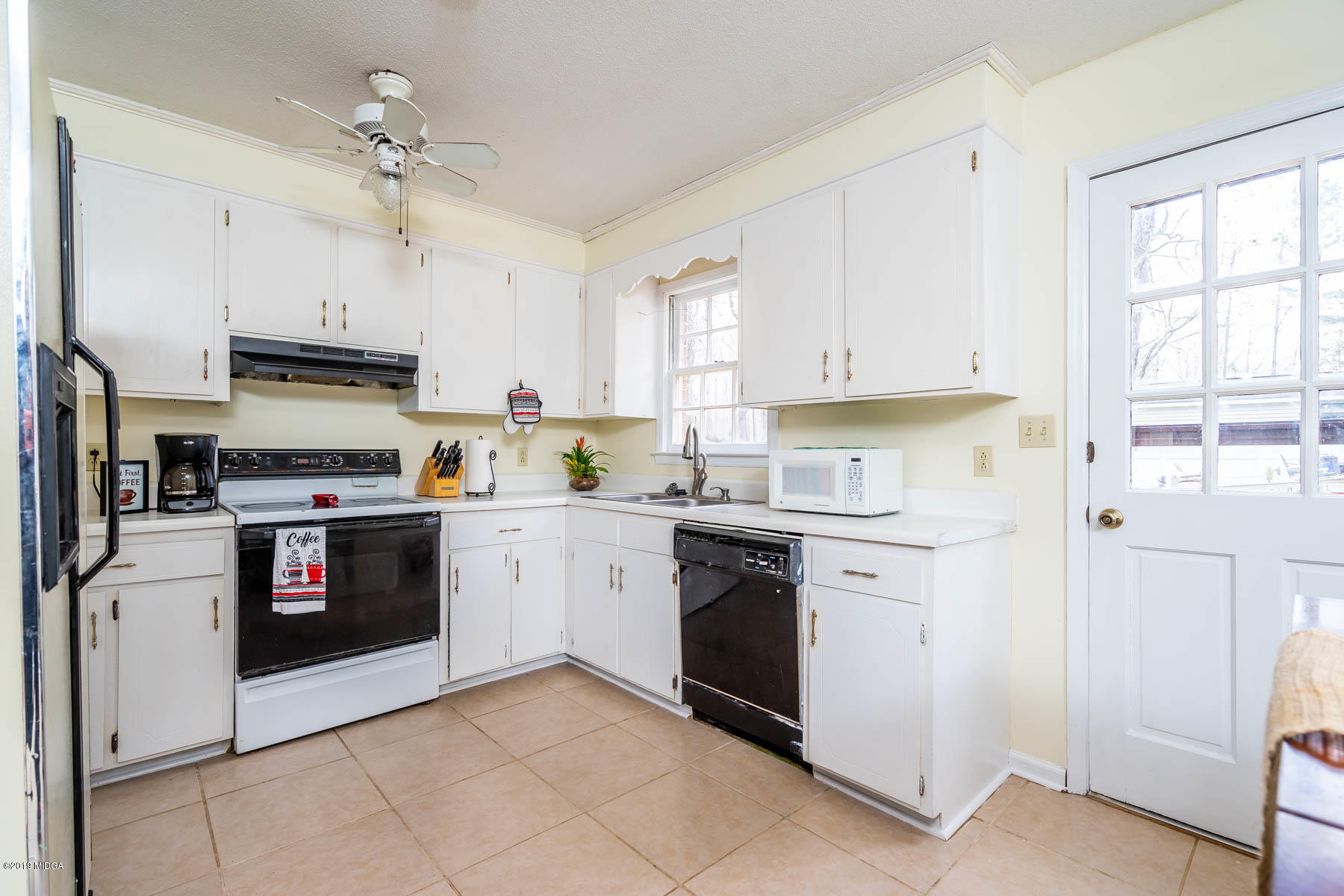 161 Taylor Road Gray, GA 31032 - Photo 4 of 13 a kitchen with granite countertop a stove top oven sink and cabinets
