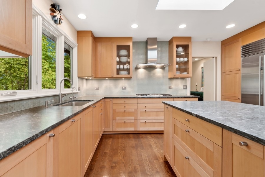 85 Riparian Road Highland Park, IL 60035 - Photo 11 of 31 a kitchen with granite countertop a sink a counter space appliances and cabinets