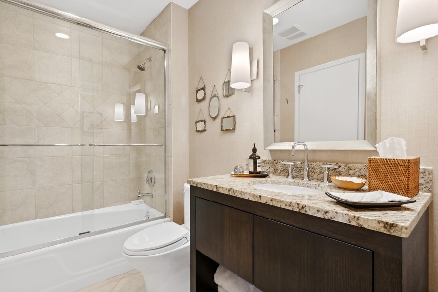 85 Riparian Road Highland Park, IL 60035 - Photo 19 of 31 a bathroom with a granite countertop sink toilet mirror and shower