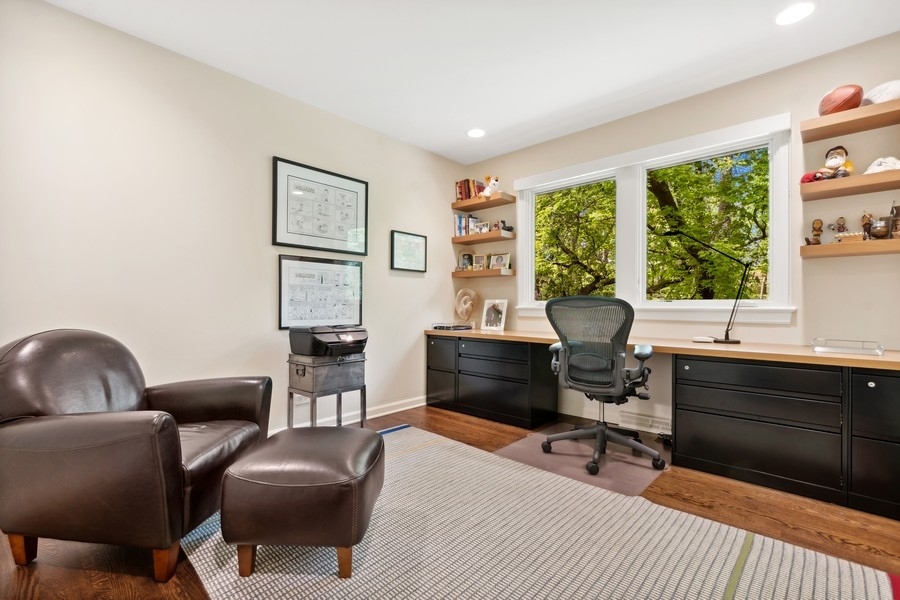 85 Riparian Road Highland Park, IL 60035 - Photo 22 of 31 a living room with furniture a fireplace and a large window