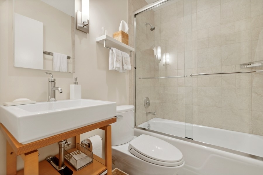 85 Riparian Road Highland Park, IL 60035 - Photo 23 of 31 a bathroom with a sink a toilet and shower