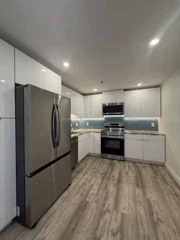 a kitchen with a refrigerator sink and oven