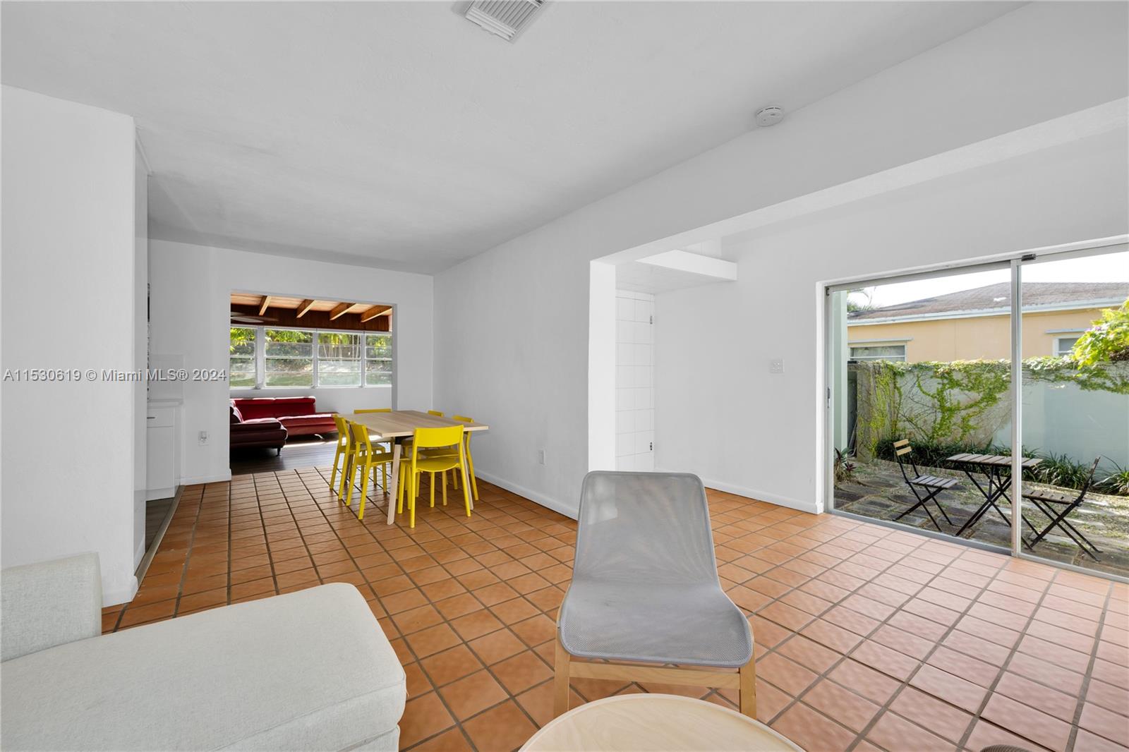 6520 Southwest 46th Street Miami, FL 33155 - Photo 14 of 40 a living room with furniture a dining table and a large window