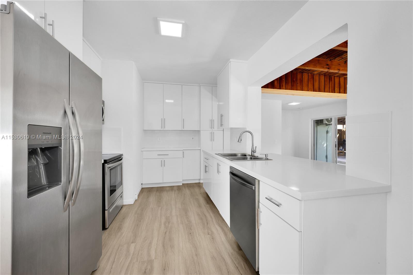 6520 Southwest 46th Street Miami, FL 33155 - Photo 16 of 40 a kitchen with a sink and refrigerator
