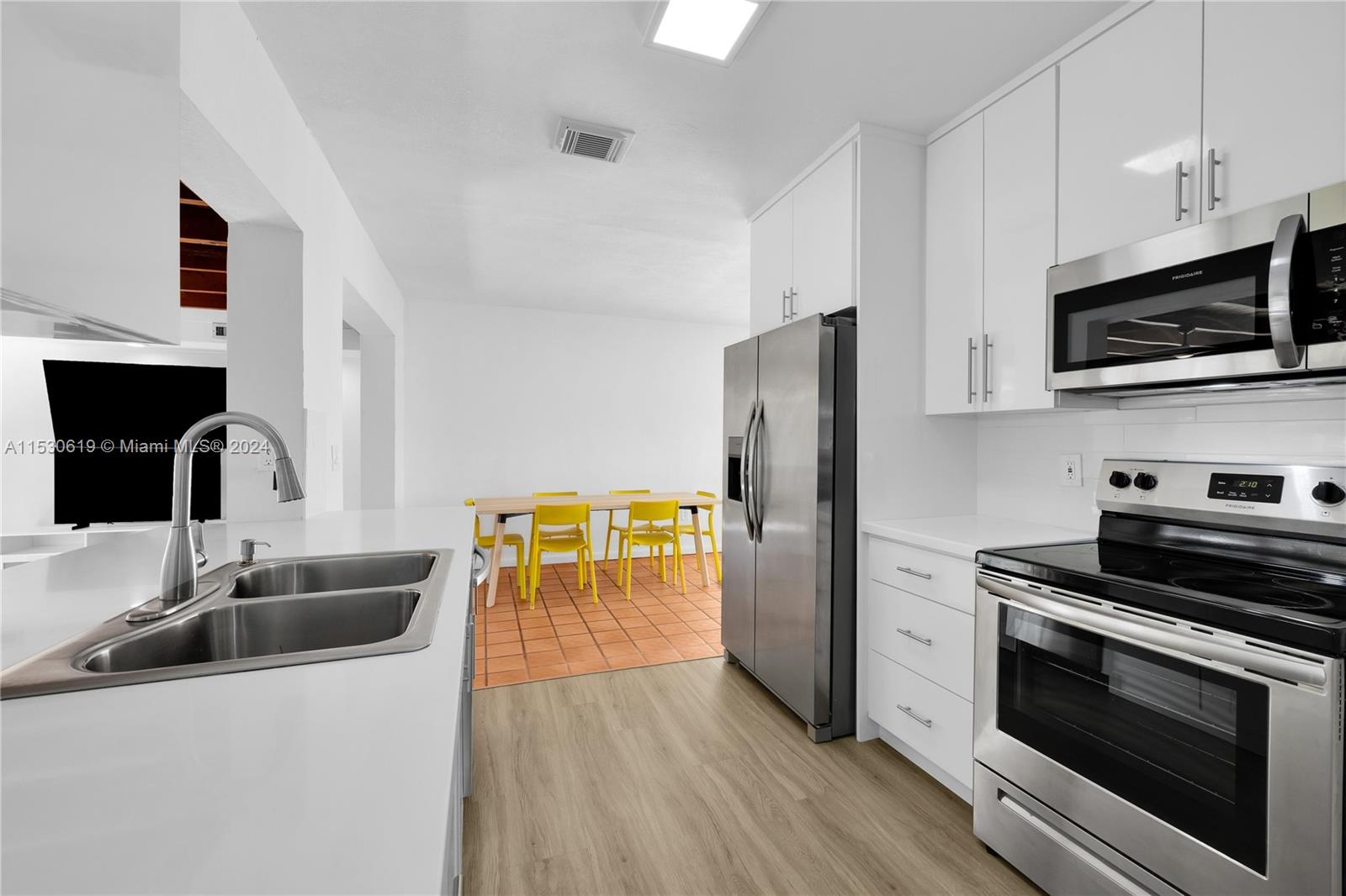 6520 Southwest 46th Street Miami, FL 33155 - Photo 18 of 40 a kitchen with stainless steel appliances a stove microwave and sink