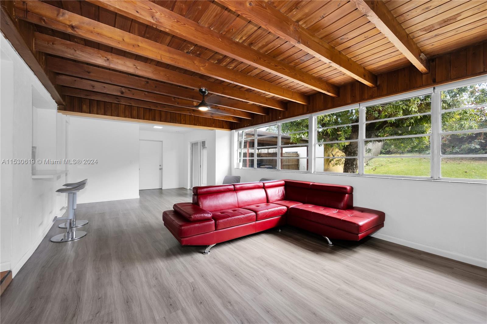 6520 Southwest 46th Street Miami, FL 33155 - Photo 22 of 40 a living room with furniture a wooden floor and next to a window