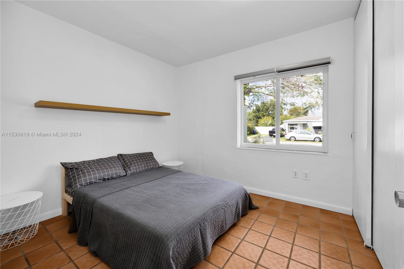 6520 Southwest 46th Street Miami, FL 33155 - Photo 23 of 40 a bedroom with a bed and a window