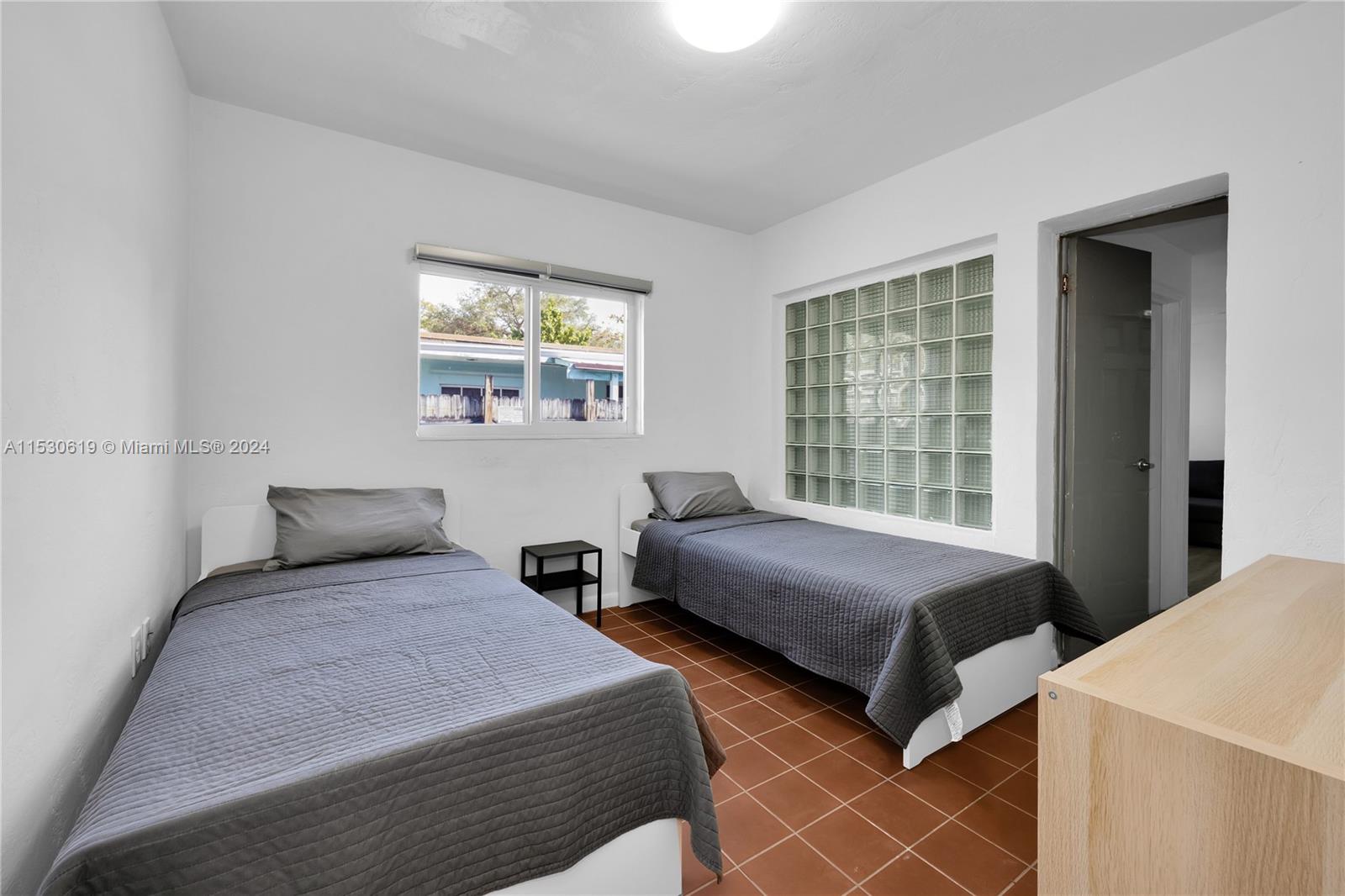 6520 Southwest 46th Street Miami, FL 33155 - Photo 25 of 40 a bedroom with two beds and a window