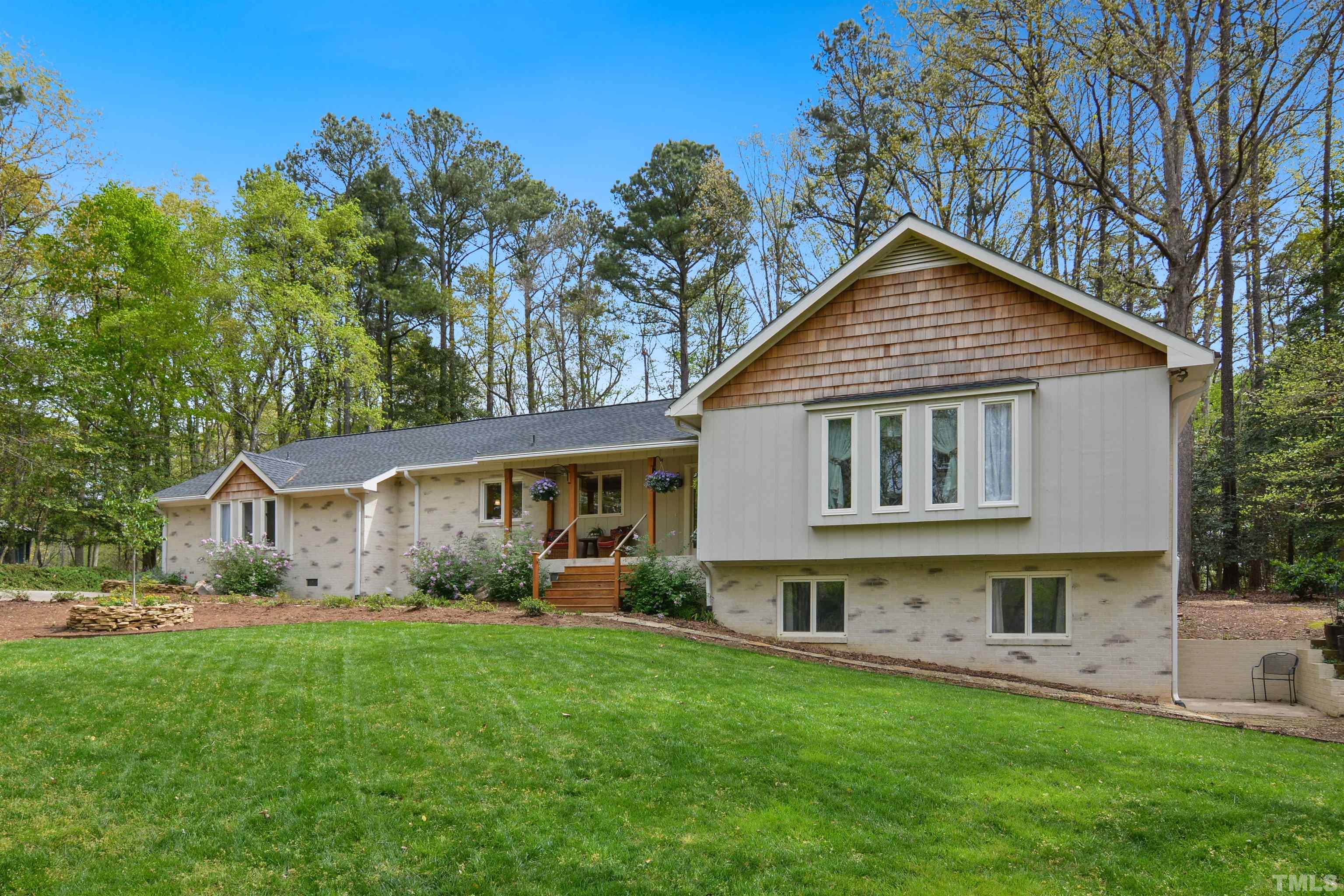 6120 Riverside Drive Wake Forest, NC 27587 - Photo 1 of 26 a front view of a house with a garden and plants