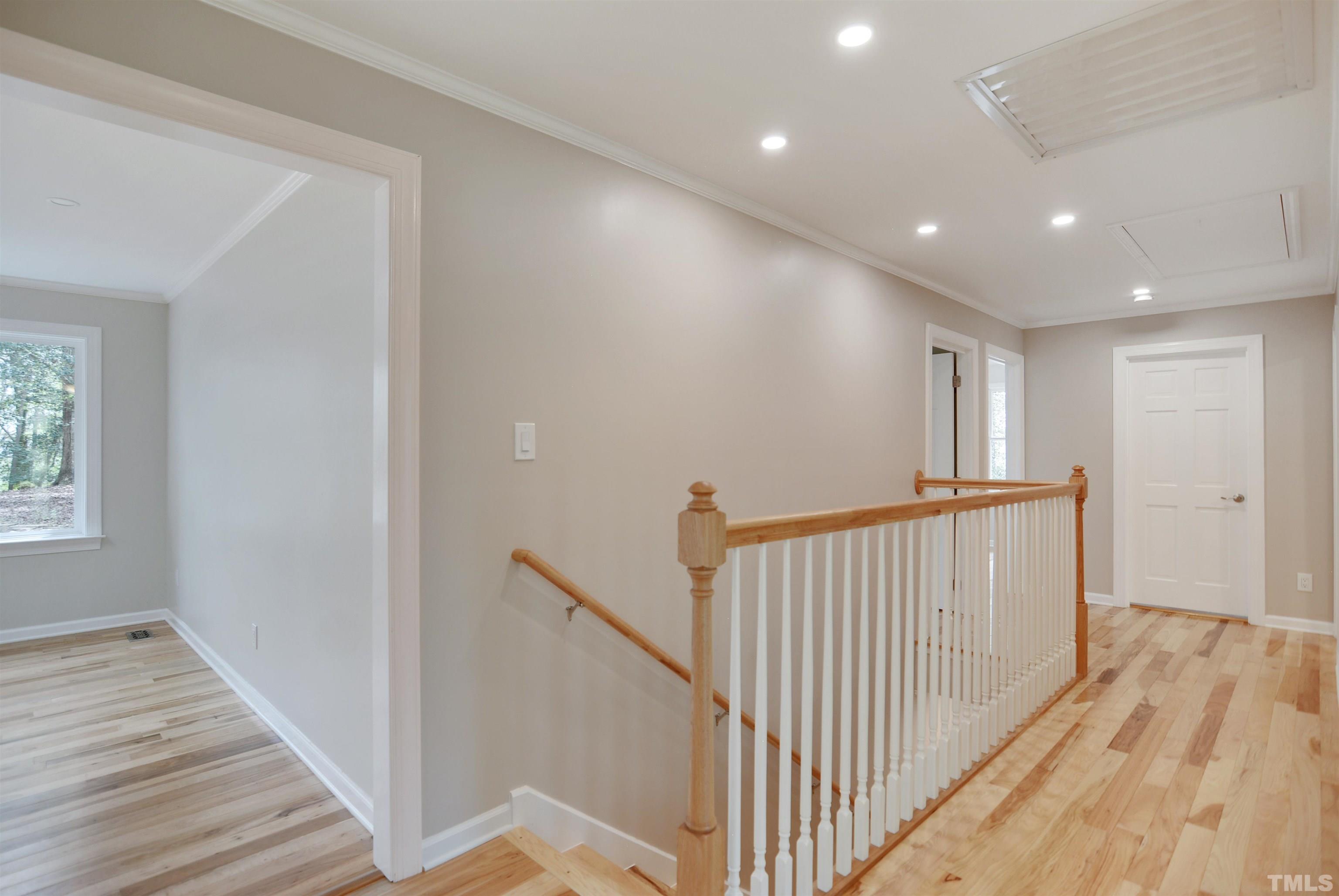 6120 Riverside Drive Wake Forest, NC 27587 - Photo 11 of 26 a view of a hallway with wooden floor and staircase