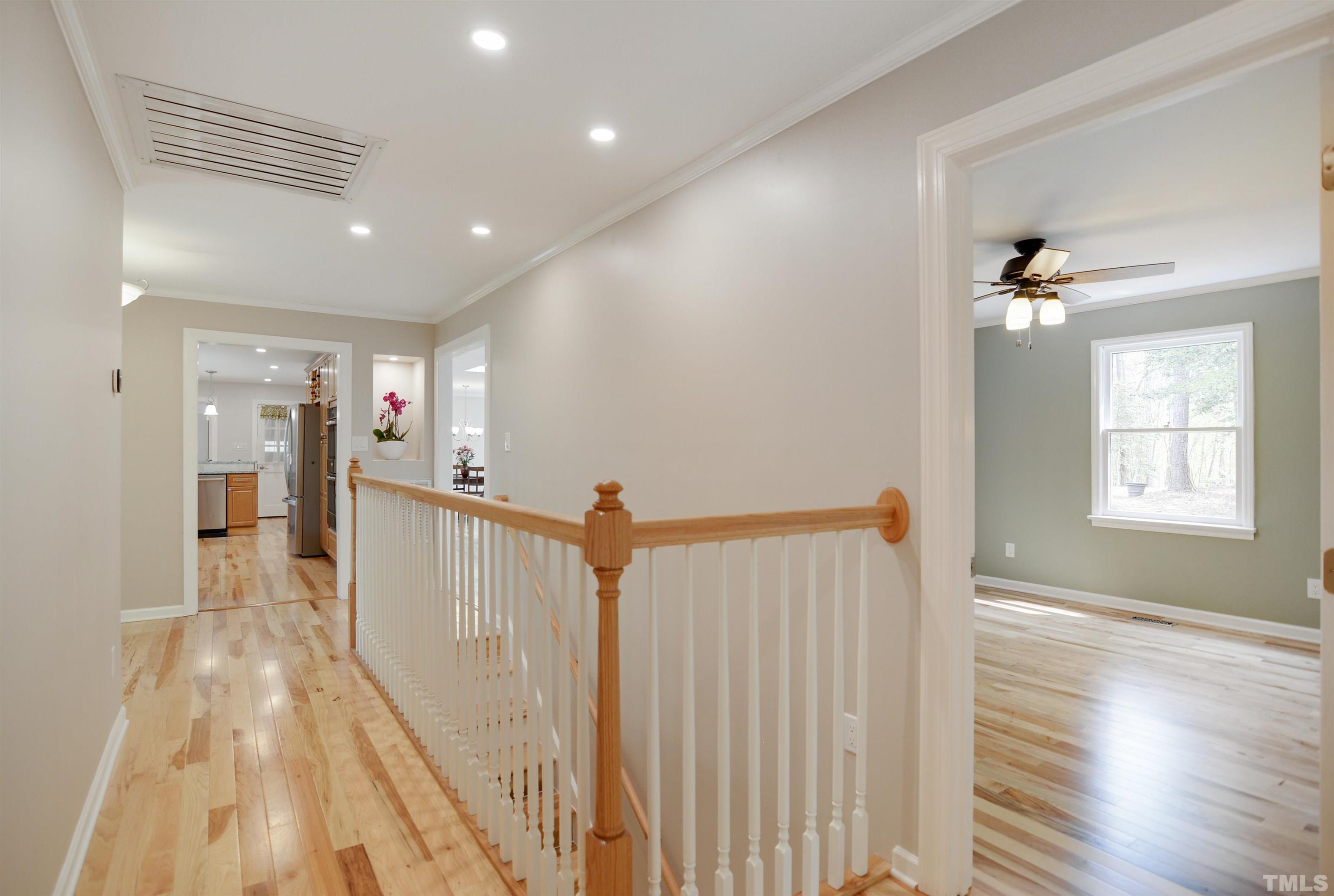 6120 Riverside Drive Wake Forest, NC 27587 - Photo 12 of 26 a view of a hallway with wooden floor and windows