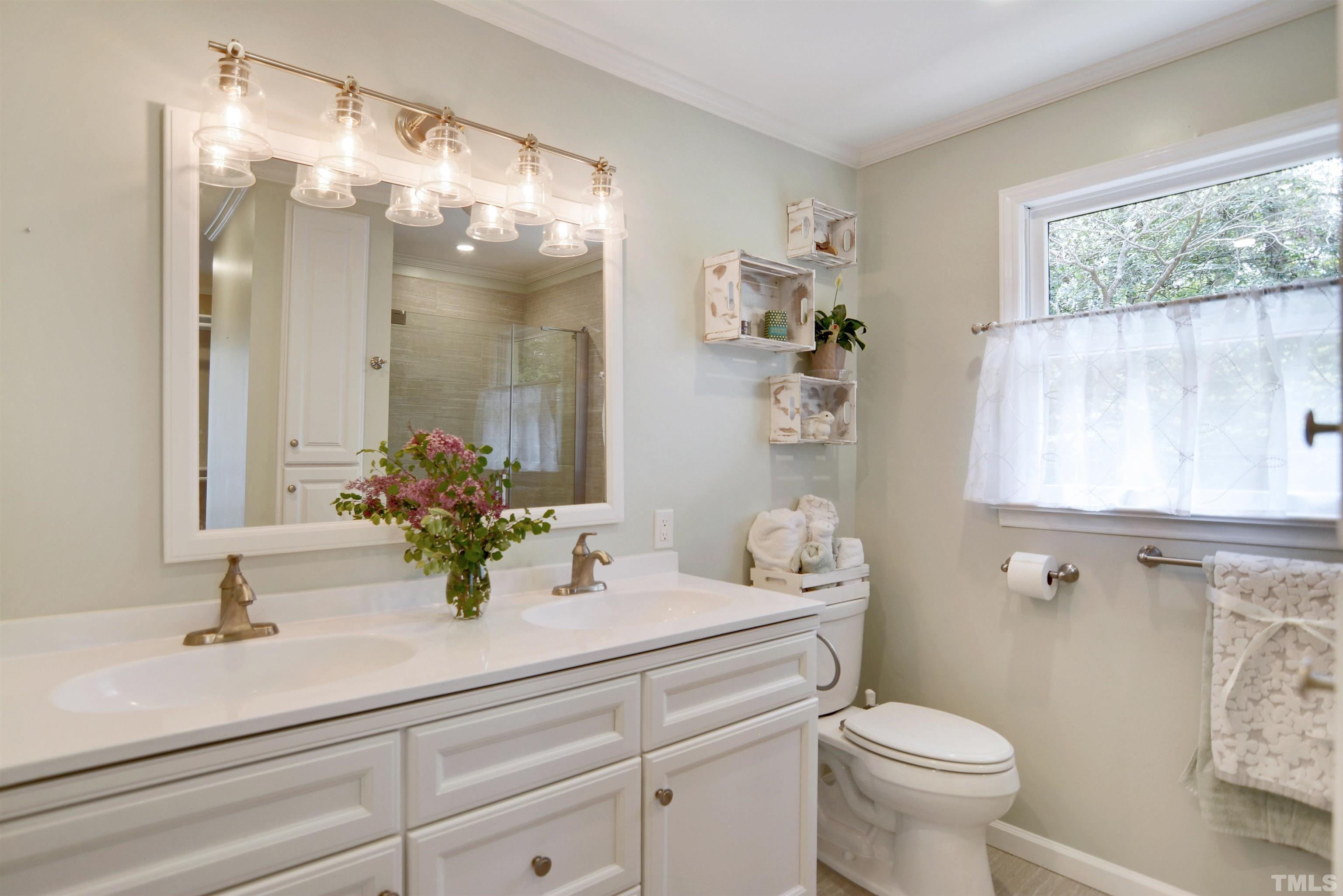 6120 Riverside Drive Wake Forest, NC 27587 - Photo 15 of 26 a bathroom with a sink a toilet and a mirror