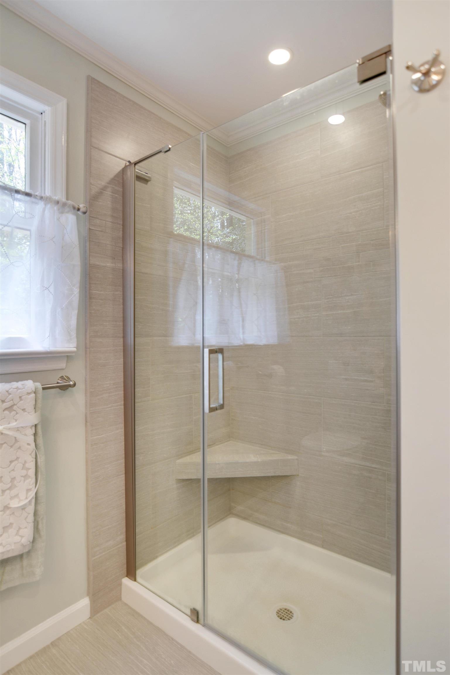 6120 Riverside Drive Wake Forest, NC 27587 - Photo 16 of 26 a bathroom with a shower and a glass door