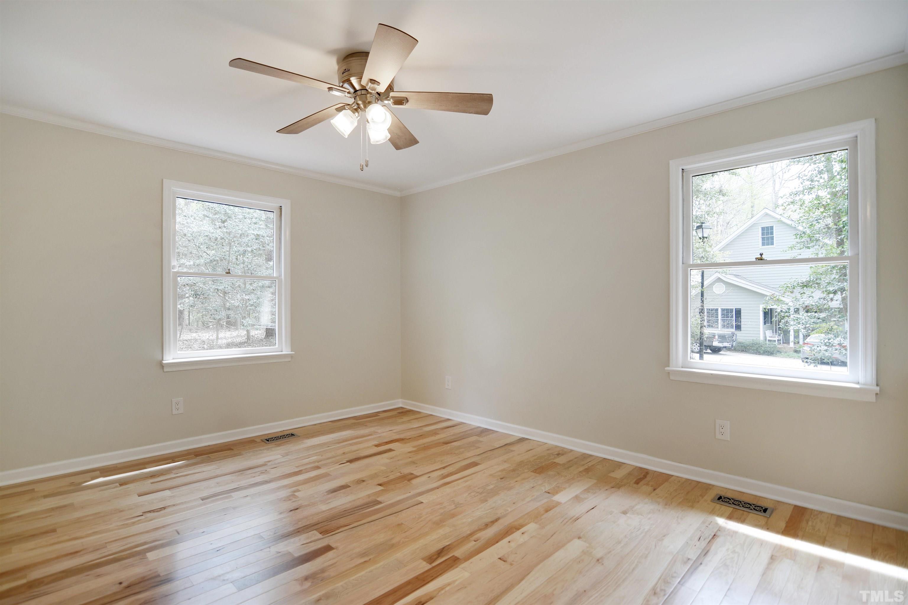 6120 Riverside Drive Wake Forest, NC 27587 - Photo 18 of 26 a view of an empty room with wooden floor and a window