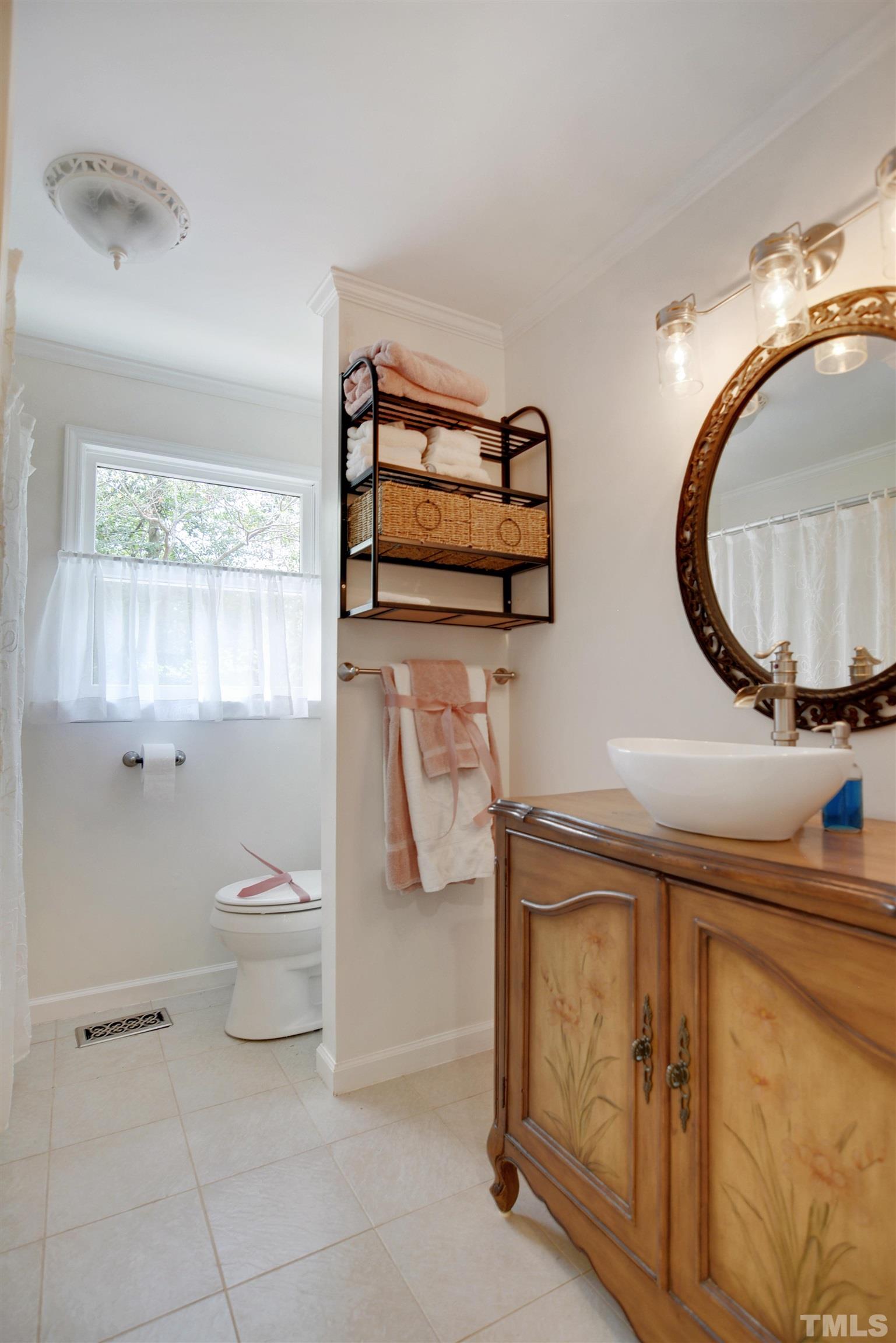 6120 Riverside Drive Wake Forest, NC 27587 - Photo 19 of 26 a bathroom with a toilet a sink and mirror