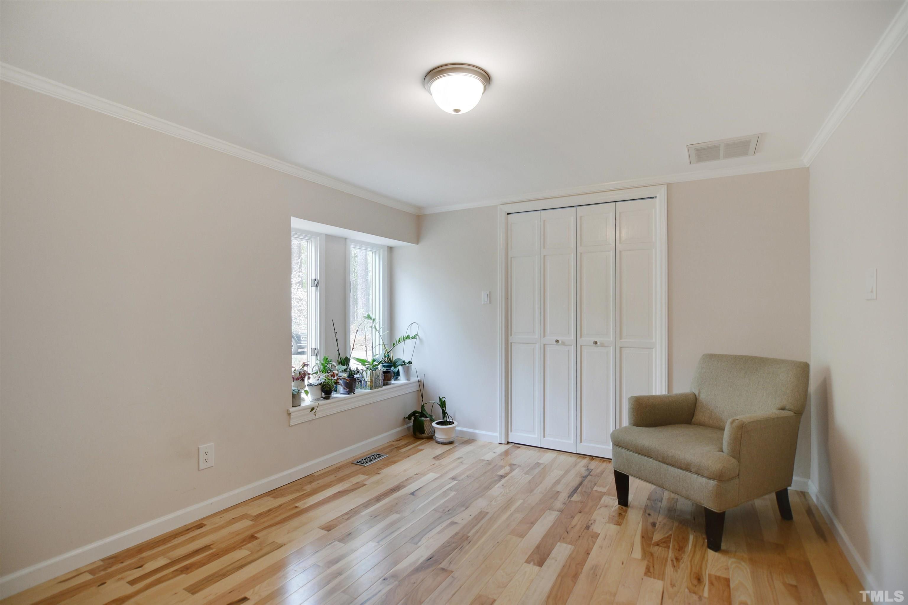 6120 Riverside Drive Wake Forest, NC 27587 - Photo 20 of 26 a spacious bedroom with a bed and a chair