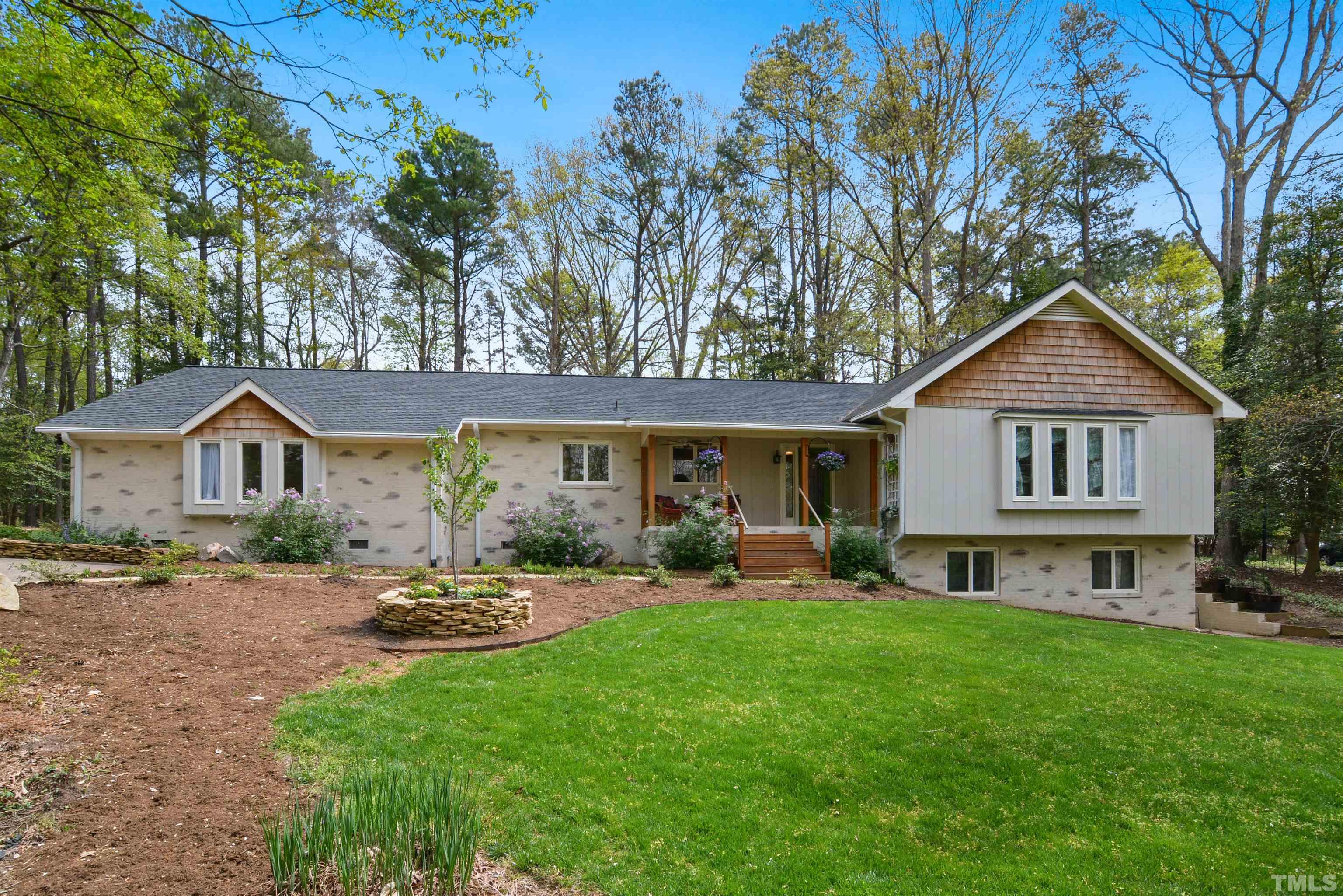 6120 Riverside Drive Wake Forest, NC 27587 - Photo 2 of 26 a front view of a house with a garden and trees