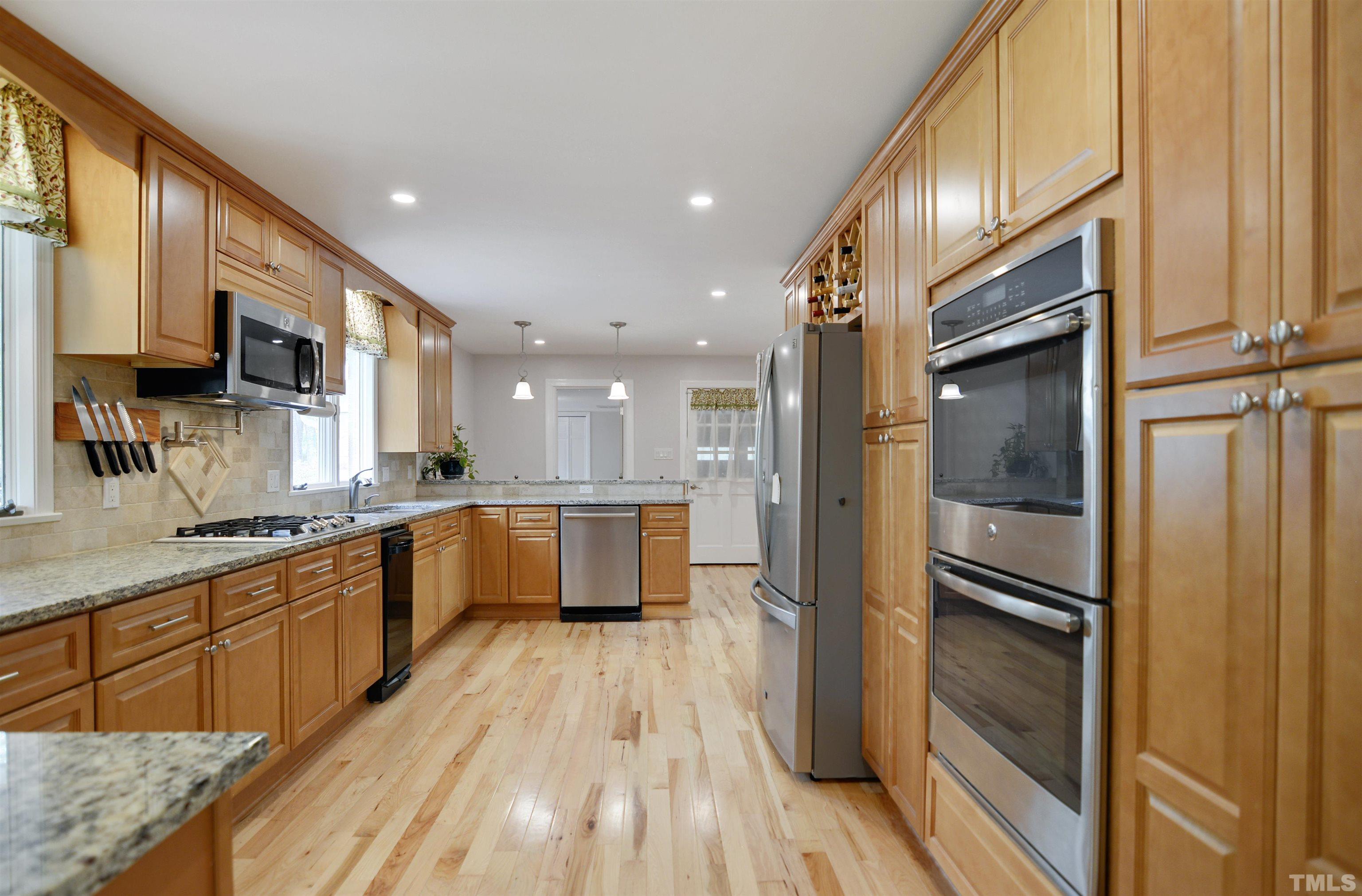 6120 Riverside Drive Wake Forest, NC 27587 - Photo 8 of 26 a large kitchen with stainless steel appliances granite countertop a refrigerator a oven a sink and a large window