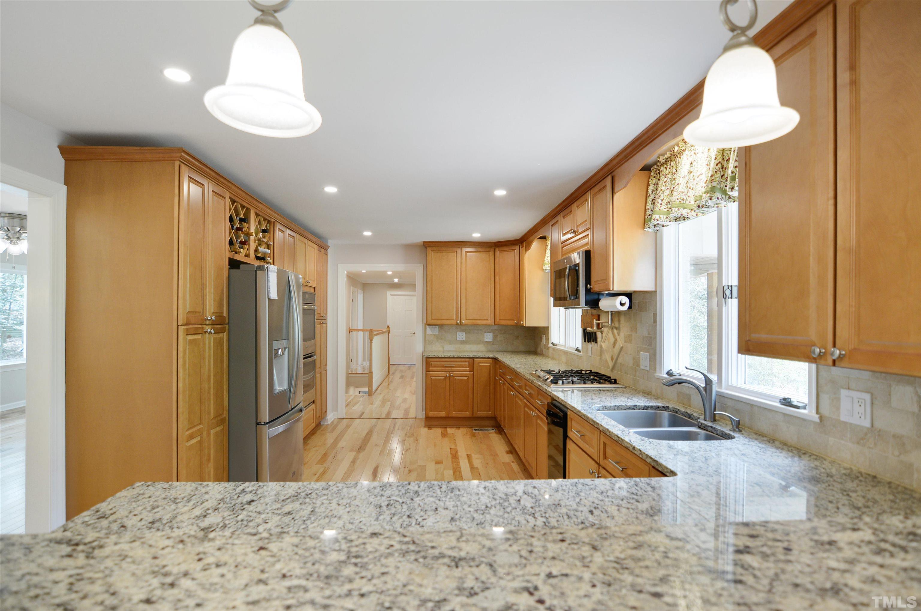 6120 Riverside Drive Wake Forest, NC 27587 - Photo 9 of 26 a kitchen with kitchen island granite countertop a sink and a counter top space