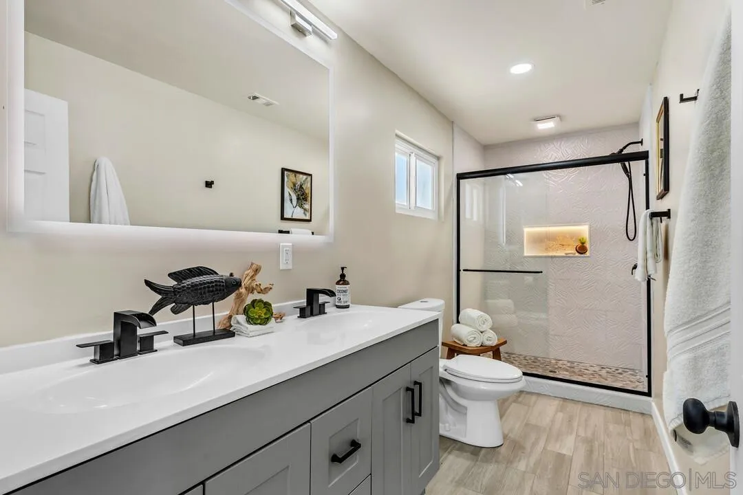 13725 Adrian Street Poway, CA 92064 - Photo 22 of 52 a bathroom with a sink a toilet and shower