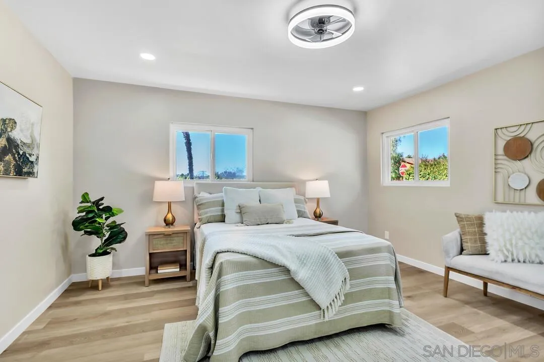 13725 Adrian Street Poway, CA 92064 - Photo 23 of 52 a bedroom with a bed and a chandelier