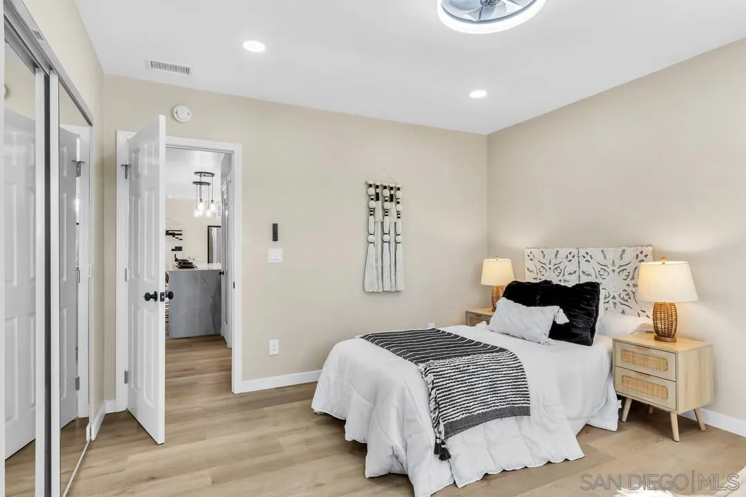 13725 Adrian Street Poway, CA 92064 - Photo 29 of 52 a bedroom with a bed and wooden floor