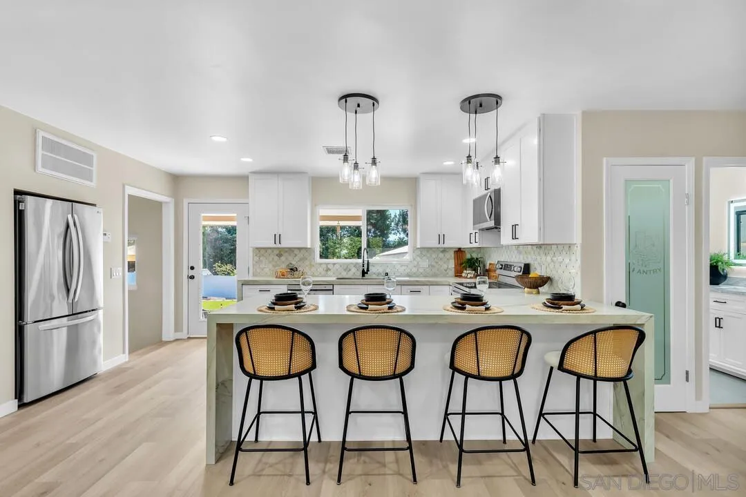 13725 Adrian Street Poway, CA 92064 - Photo 8 of 52 a kitchen with sink and refrigerator