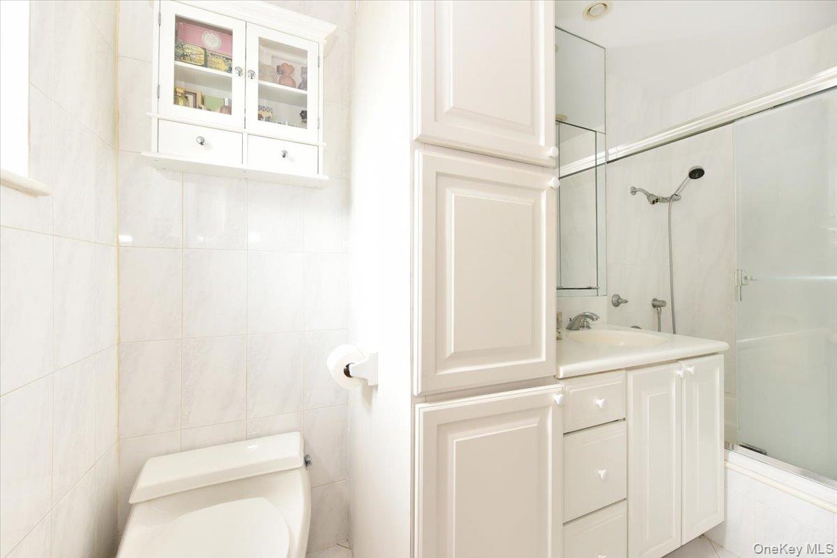 40 Stoner Avenue, Unit 1I Great Neck, NY 11021 - Photo 17 of 22 a bathroom with a sink a toilet and shower