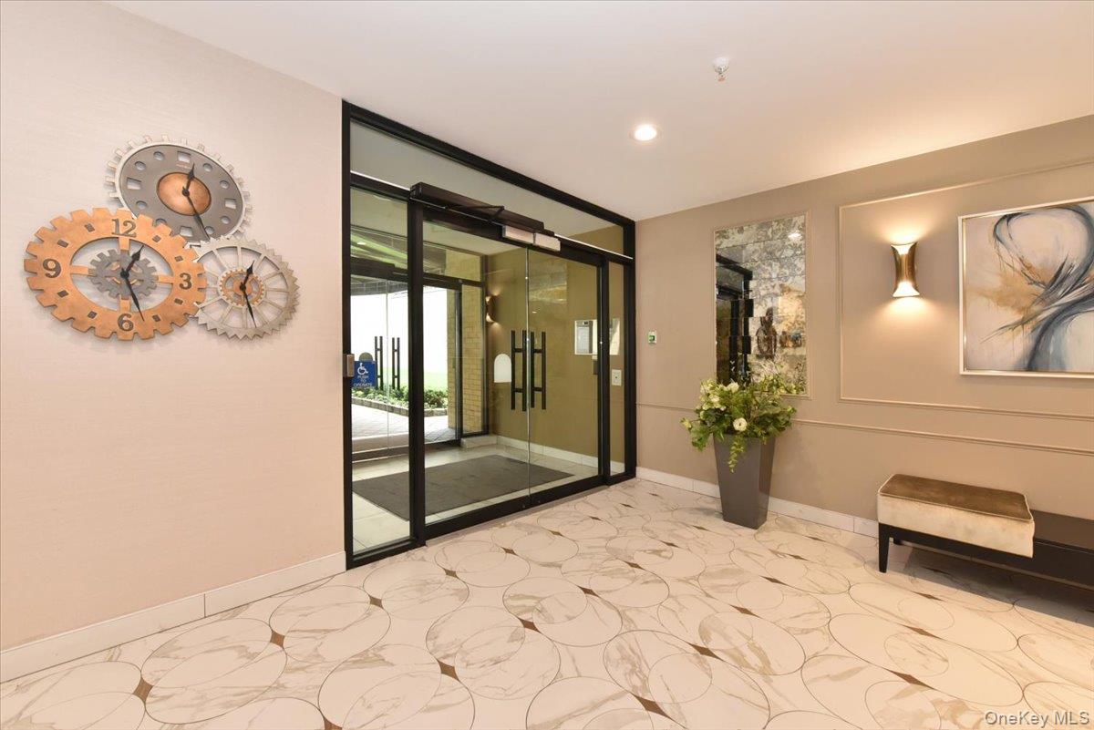 40 Stoner Avenue, Unit 1I Great Neck, NY 11021 - Photo 2 of 22 a view of an entryway with wooden floor
