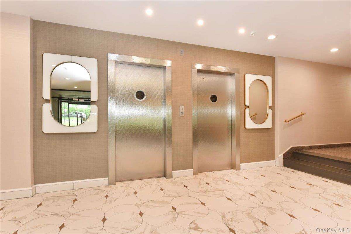 40 Stoner Avenue, Unit 1I Great Neck, NY 11021 - Photo 7 of 22 a bathroom with a sink and a mirror