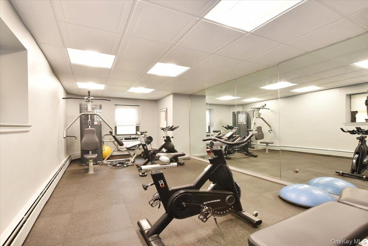 40 Stoner Avenue, Unit 1I Great Neck, NY 11021 - Photo 8 of 22 a room with gym equipment and a table