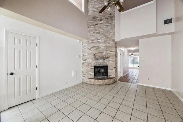 a view of an empty room with a fireplace