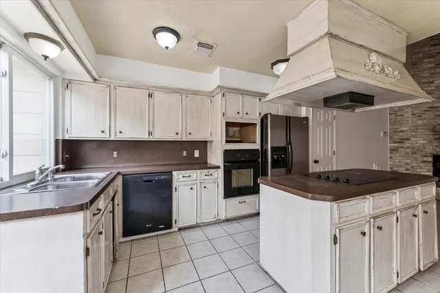 a kitchen with stainless steel appliances granite countertop a sink and cabinets