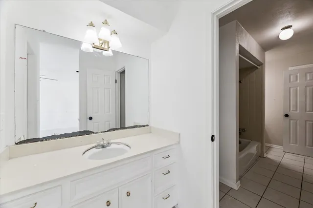 a bathroom with a double vanity sink and a mirror