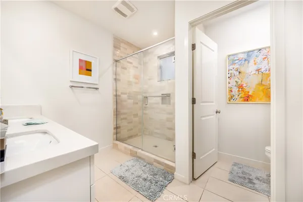 a bathroom with a shower and sink
