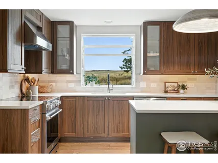 a kitchen with stainless steel appliances granite countertop a sink stove and cabinets