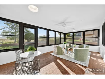 a living room with furniture window and cabinet