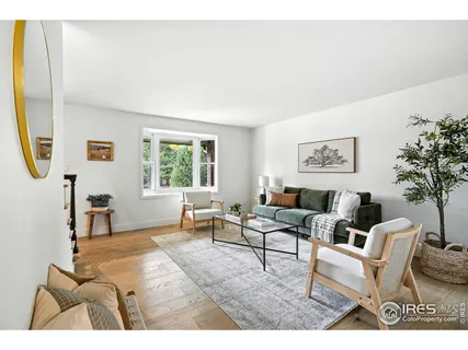 a view of a dining room with furniture wooden floor and a chandelier