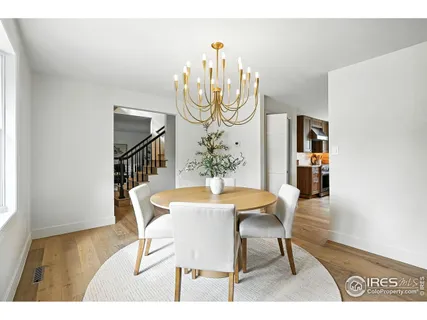 a kitchen with stainless steel appliances granite countertop a sink a stove a dining table and chairs