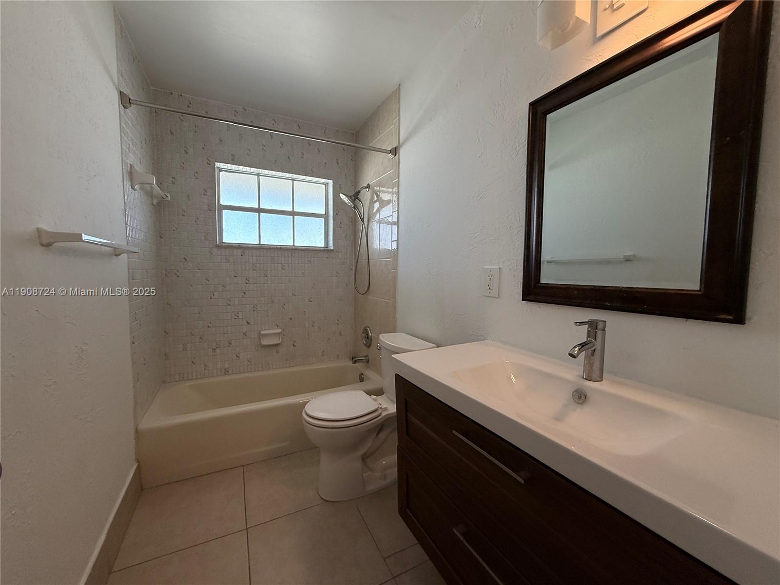 8900 West Sample Road, Unit 204 Coral Springs, FL 33065 - Photo 12 of 21 a bathroom with a sink a toilet and shower